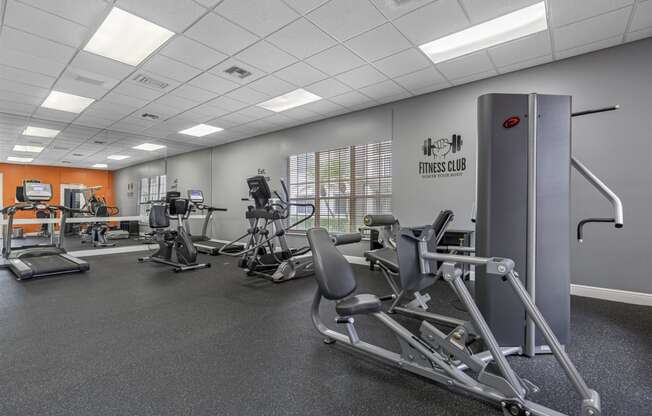 a gym with exercise equipment and weights in a building