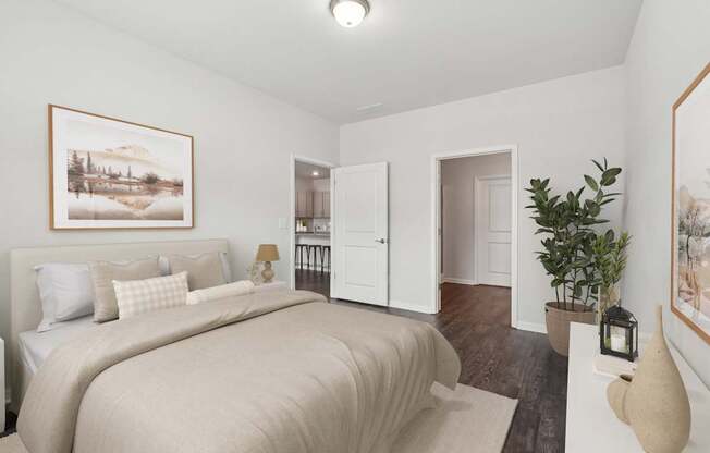 A bedroom with a large bed and a painting on the wall.