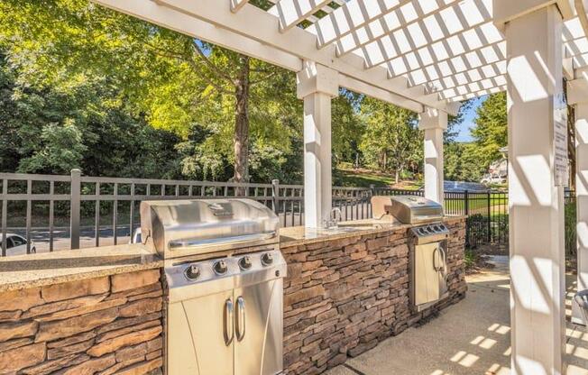 a patio with a barbecue grill and a stone wall at Marina Point, Chattanooga, 37415