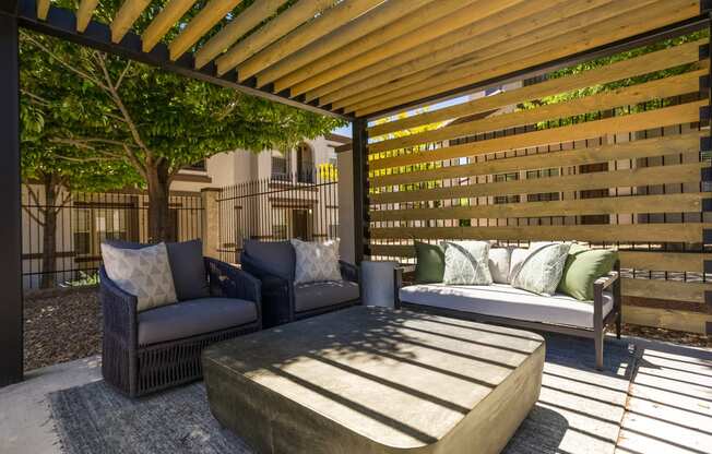 a patio with a couch and chairs and a coffee table