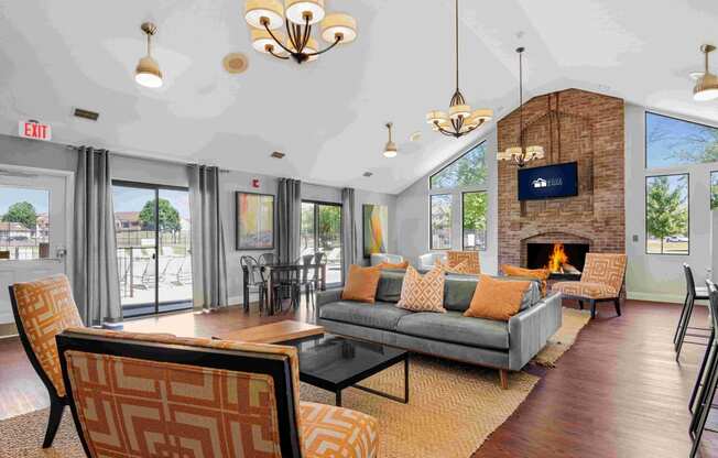 a living room with couches and chairs and a fireplace