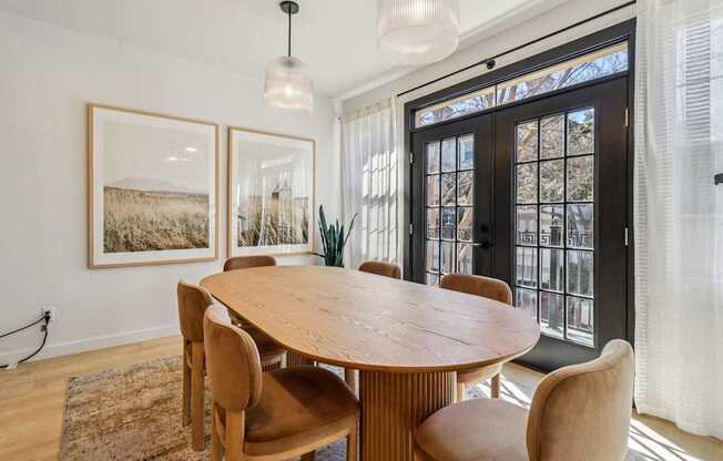 A dining room with a wooden table and chairs.