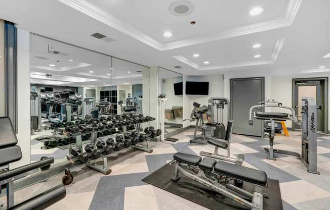 a spacious fitness center with state of the art exercise equipment and mirrors  at Apex Mission Valley, San Diego