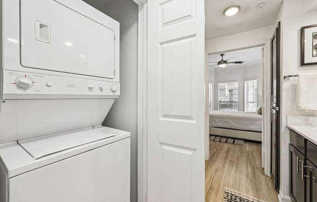 A white washing machine and dryer in a small laundry room.