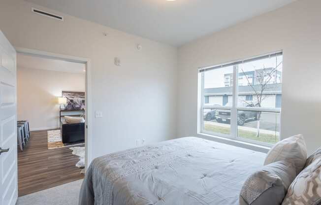a bedroom with a large bed and a large window