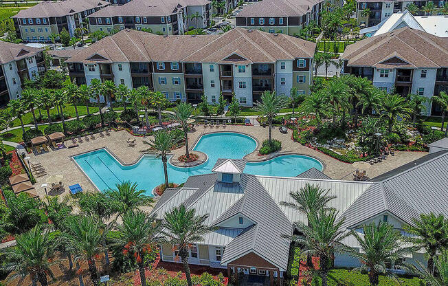 an aerial view of a resort style swimming pool with palm trees  at Cabana Club - Galleria Club, Florida