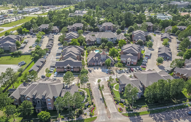 A bird's eye view of a residential neighborhood with houses and trees.
