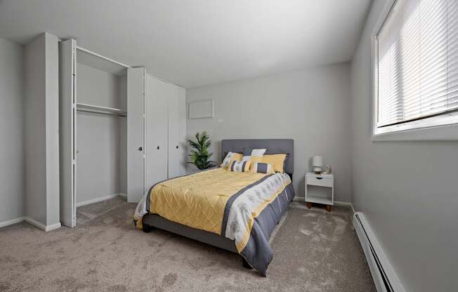 A bedroom with a bed, nightstand, and a plant.