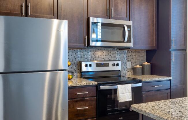 kitchen with stainless appliances and custom cabinetry at Artisan on 18th, Nashville, 37203