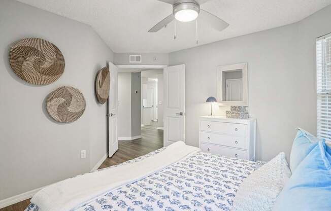 A bedroom with a bed, dresser, and mirror.