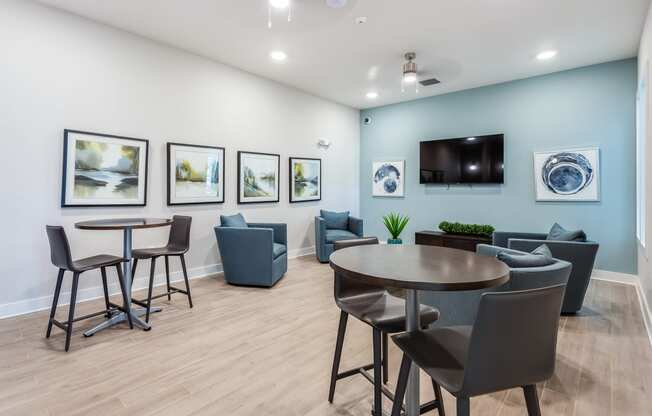 a room with a table and chairs and a flat screen tv on the wall