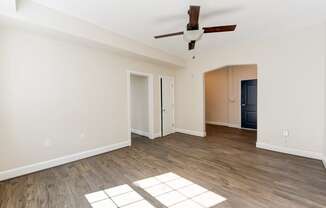 vacant living area with wood flooring and ceiling fan at petworth station apartments in washington dc