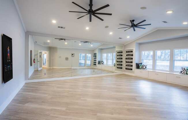 a large living room with a hardwood floor and a ceiling fan