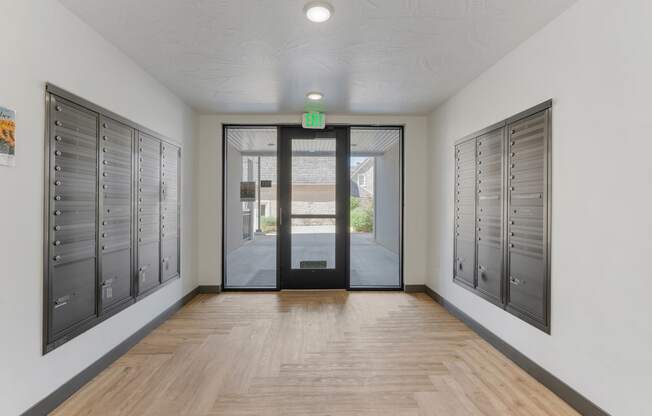 a hallway with lockers and a door to a building