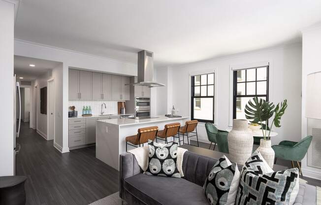the living room and kitchen of an apartment with a couch and a table  at The Belden Stratford, Chicago, 60614