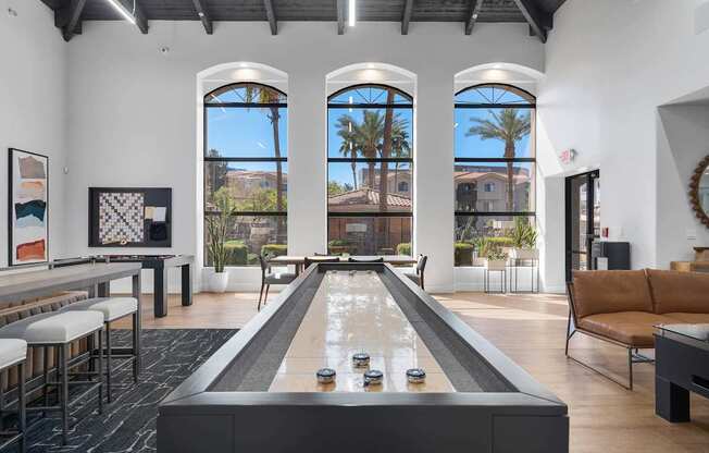A billiard table is in the middle of a room with a pool table and a couch.
