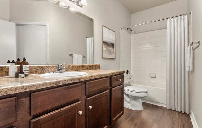 a bathroom with a sink toilet and shower