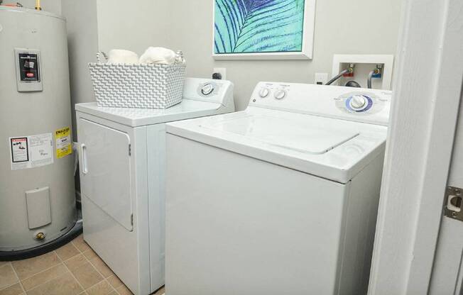 a white washer and dryer in a room with a refrigerator