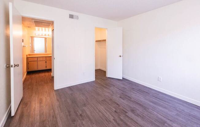 A room with a wooden floor and white walls.