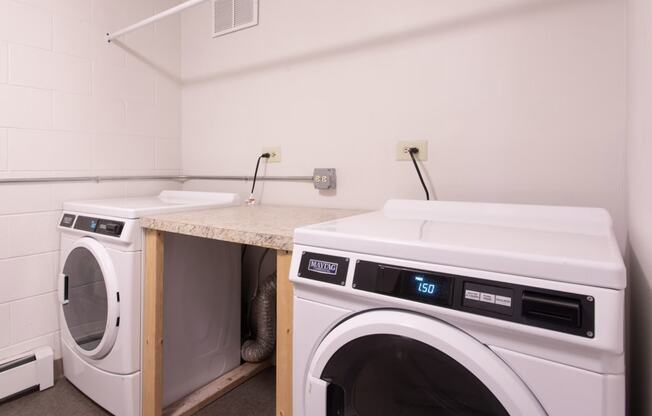 a washer and dryer in a laundry room with a counter and two was