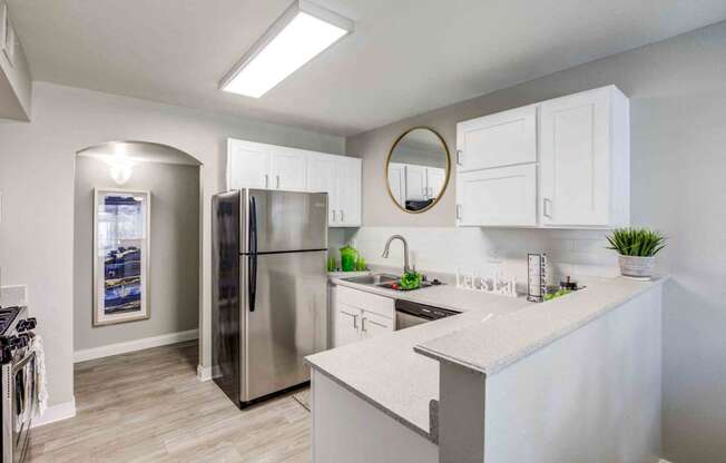a kitchen with a stainless steel refrigerator and a counter top
