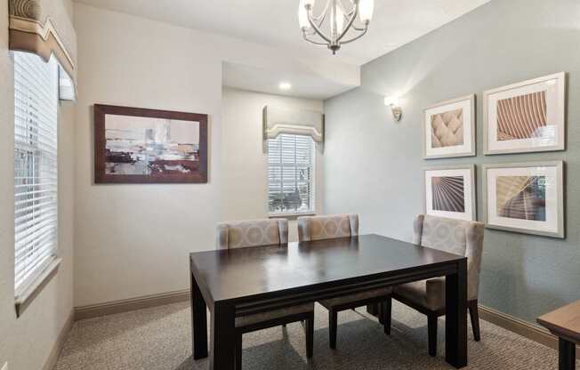 A dining room with a table and chairs.