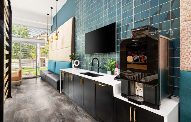 a kitchen with blue tiles and a coffee machine