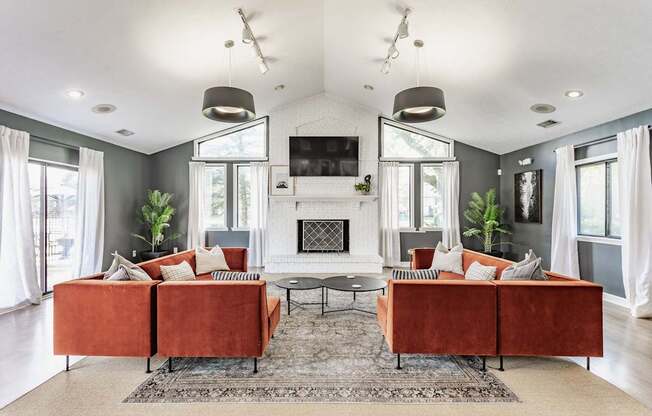 A living room with a fireplace and a television.