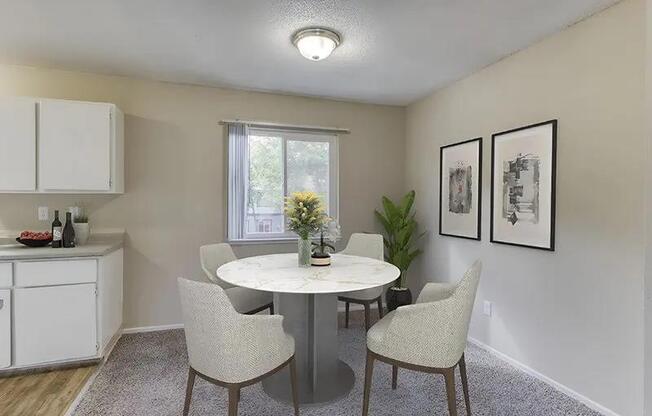 A dining room with a white table and chairs.