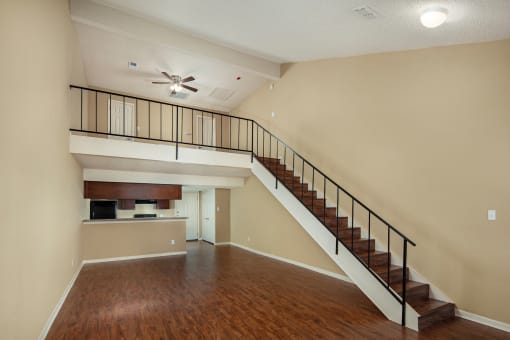 an open living room with a staircase leading to the second floor