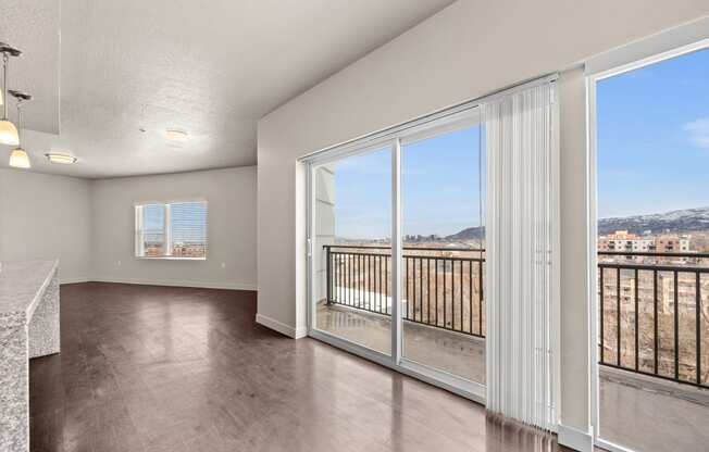 a living room with a large window and a balcony