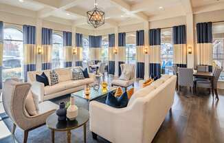 a living room with couches and chairs and a table  at Orion Prosper Lakes, Texas