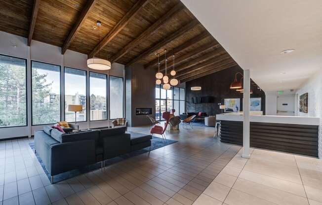 the living room and kitchen of a modern house with large windows at Ashford Belmar Apartments, Lakewood, 80226