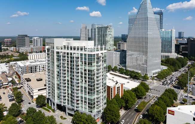 an aerial view of a city with tall buildings and trees