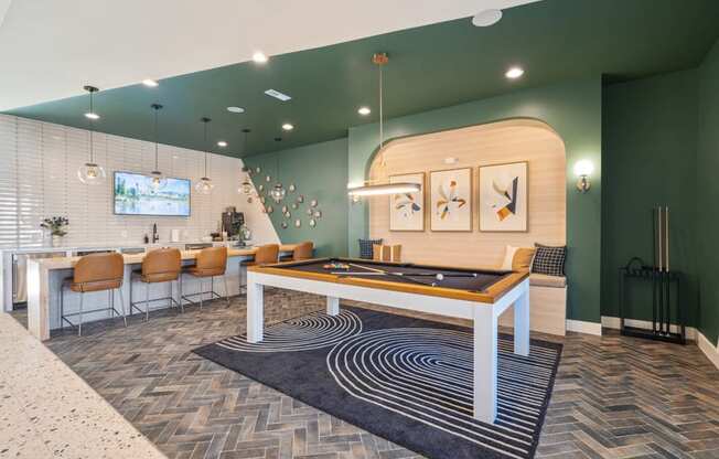 A billiard table is in the middle of a room with a television and a pool table.