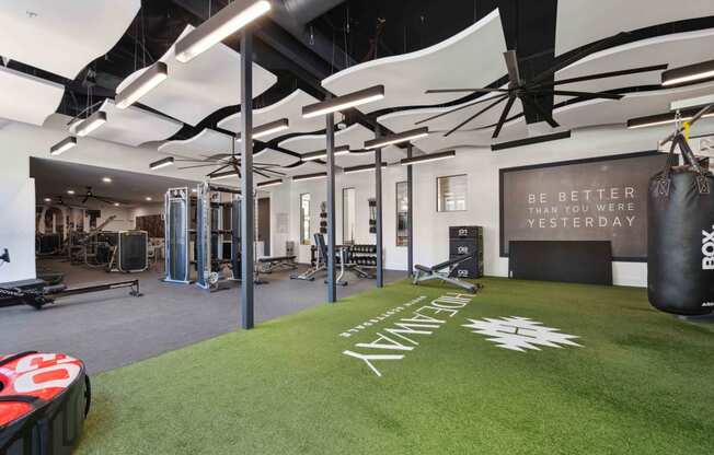 fitness center with a punching bag and weights on it