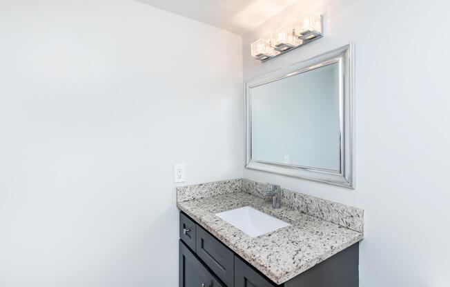 a kitchen with a sink and a mirror