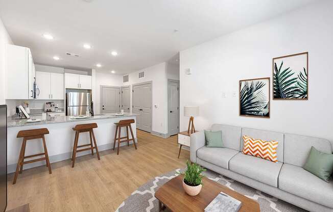 A modern living room with a grey couch and a wooden coffee table.