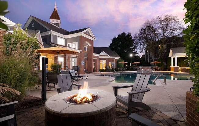 A backyard with a fire pit and a pool.