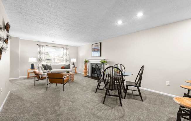 A living room with a grey carpet and furniture.