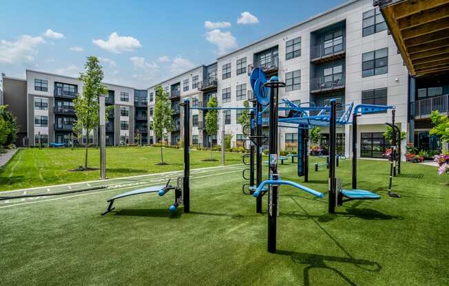 a playground in front of an apartment building