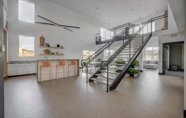 a staircase in a the club room with a kitchen and open space