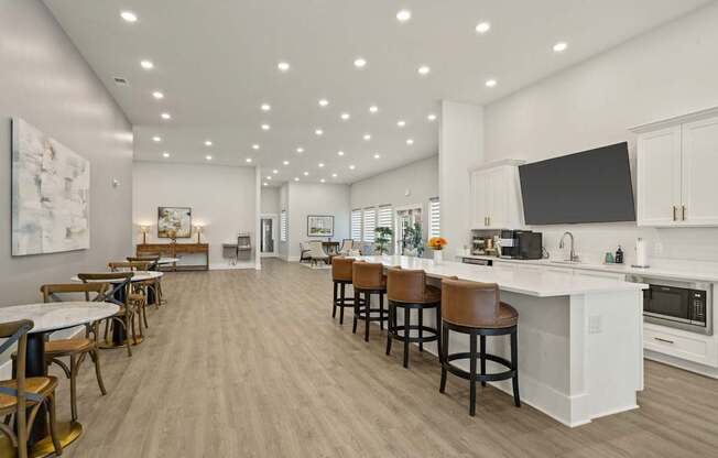 A modern kitchen with a bar area and a dining table.