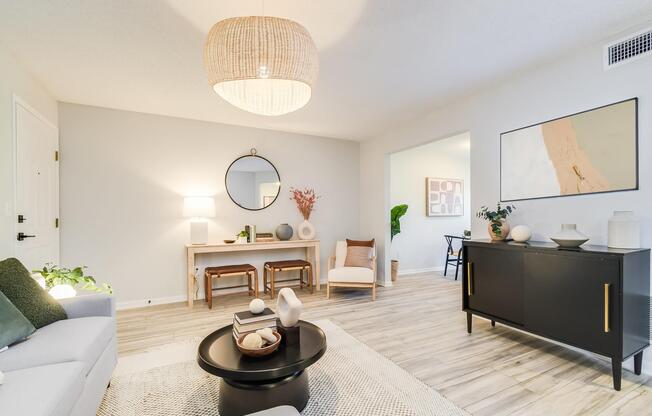 Platinum living room interior with area carpeting, couch and furniture at The Arbor in Blue Springs