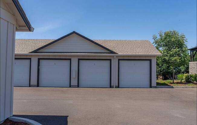A building with a brown roof and white garage doors at Northplace Apartment Homes, Salem, OR