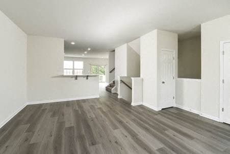 an empty living room with white walls and wooden floors