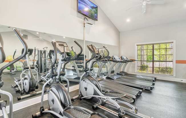 the gym has cardio machines and treadmills and a tv at Reserve of Jackson Apartment Homes, Jackson