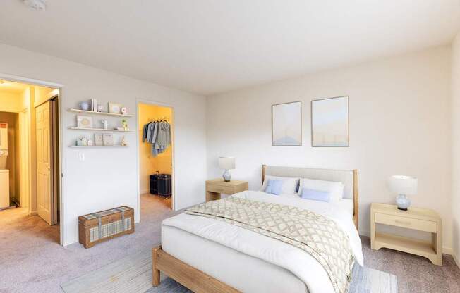 A bedroom with a bed, nightstand, and a closet with clothes hanging.