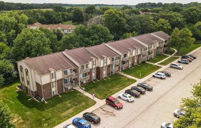 an aerial view of an apartment complex with cars parked in front at Beacon Hill and Great Oaks Apartments, Rockford, IL
