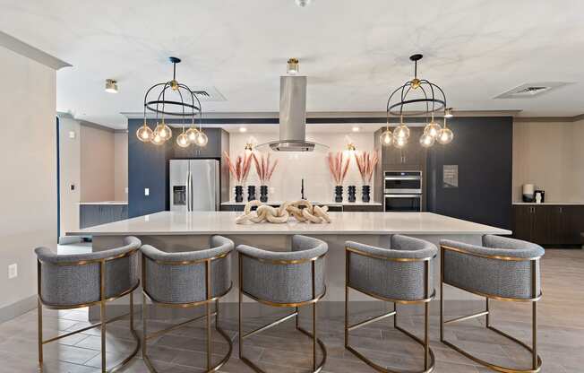 a large kitchen with a large island and a row of stools at The Griffin Royal Oak, Royal Oak, 48067